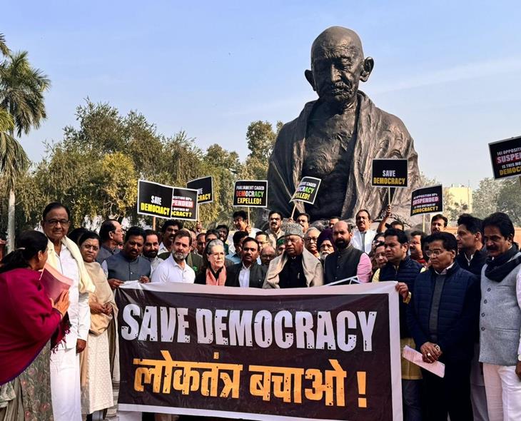 Suspended MPs Protest In Front Of Gandhi Statue In Parliament